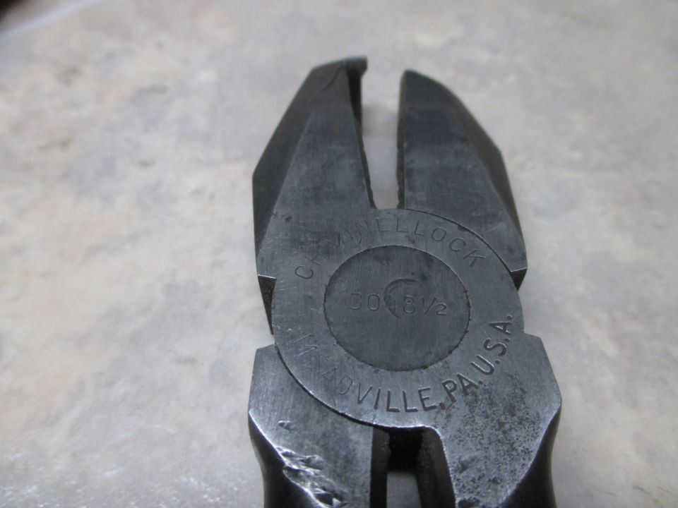 Close-up of wire cutters with 'CHAMPION DE Tool' and '30 8 1/2' stamped on the pivot
