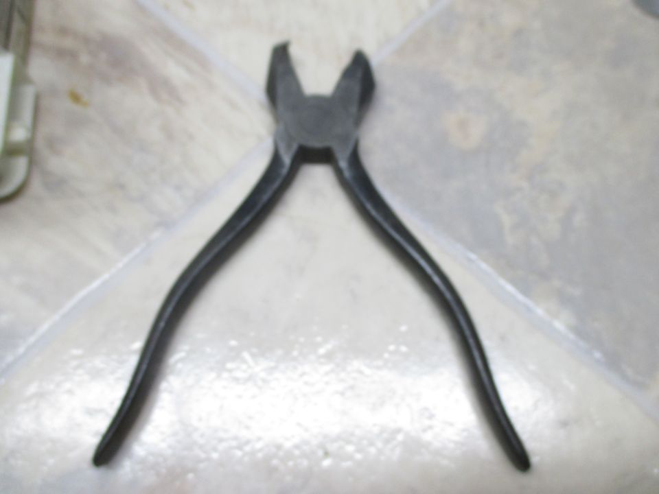 Pliers on a tiled surface