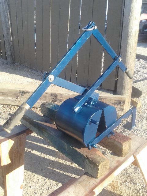1991 Ford Bronco - A blue metal tool, possibly for landscaping or construction, is shown outdoors on wooden supports.
