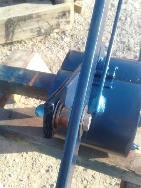 1991 Ford Bronco - A close-up view of a blue painted metal component, possibly part of a larger assembly, is shown outdoors.