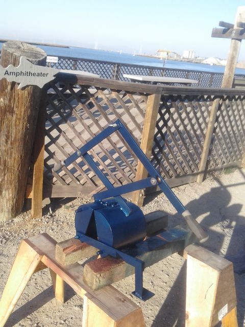 1991 Ford Bronco - A blue mechanical device sits on wooden supports near a wooden fence and a sign indicating 'Amphitheater'.