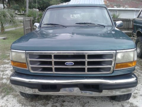 1996 Ford Bronco - The front grille and headlights of a teal Ford Bronco are visible in this photo.