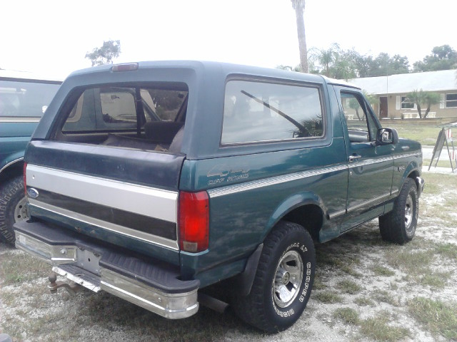 1996 Ford Bronco, rear quarter view. Another vehicle is partially visible to the left