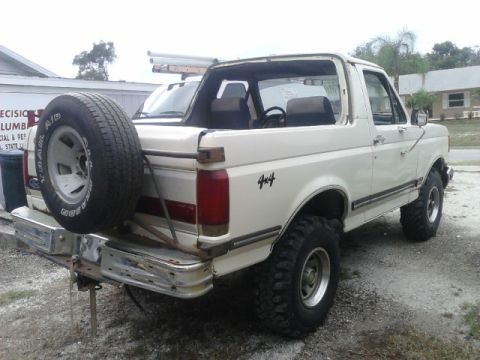 1988 Ford Bronco - This 1988 Ford Bronco is shown from a 3/4 front angle, its iconic body style and a rear-mounted spare tire.