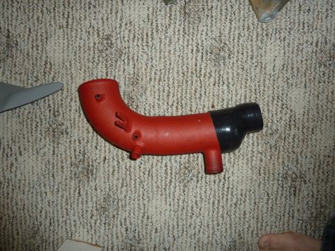 2007 Subaru Impreza - A red and black intake hose is shown on a carpeted surface.