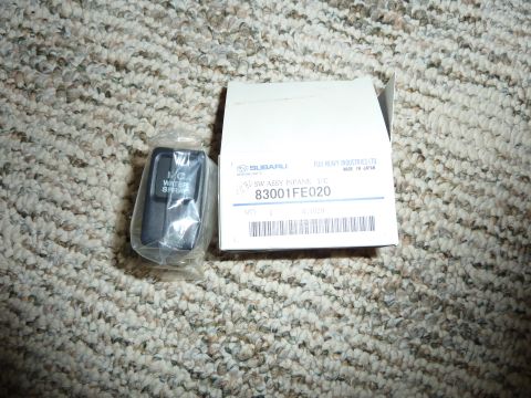 2007 Subaru Impreza - A Subaru water spray switch, part number 83001FE020, is shown in its packaging alongside the original box.