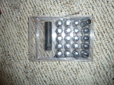 2007 Subaru Impreza - A set of lug nuts and a socket are displayed in their original packaging.