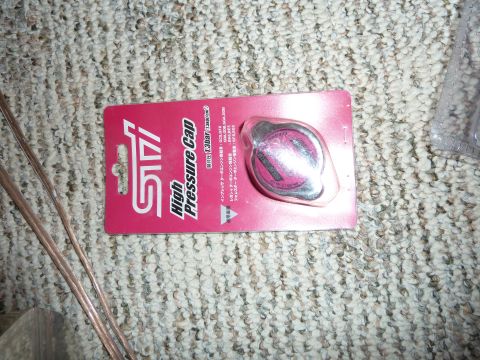 2007 Subaru Impreza - A Subaru STI branded high pressure radiator cap is shown in its retail packaging.