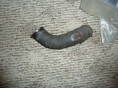 2007 Subaru Impreza - A single automotive hose is shown lying on a carpet, with a plastic bag in the background.