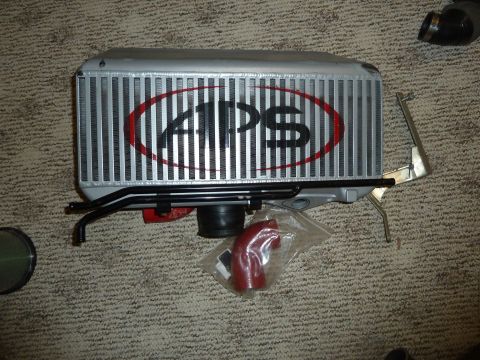 2007 Subaru Impreza - APS intercooler and associated parts laid out on a carpeted surface.