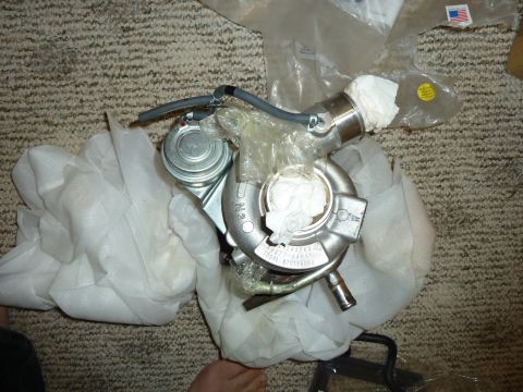2007 Subaru Impreza - A turbocharger is shown, partially unwrapped, with some part numbers visible on its casing.