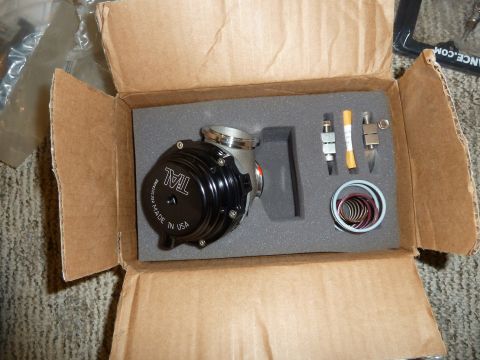 2007 Subaru Impreza - A black blow-off valve, labeled 'TAL MADE IN USA', is presented in its original packaging with included accessories.