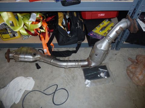2007 Subaru Impreza - Catalytic converter part shown on the floor with storage shelves in the background.