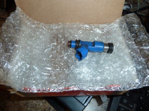 2007 Subaru Impreza - A blue fuel injector is shown, packaged in bubble wrap inside a cardboard box.