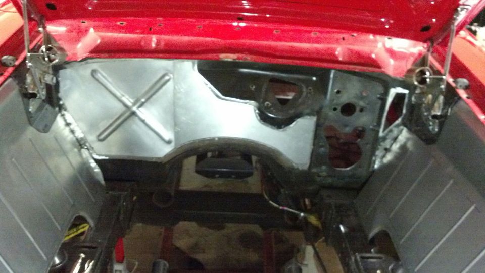 Red car engine bay firewall with metal bracing