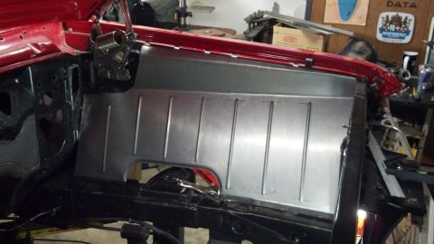 1964 Ford Fairlane - Bare metal firewall panel with vertical indentations, part of a car's engine bay construction.