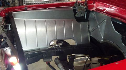 1964 Ford Fairlane - Close-up of a car's firewall showing a newly installed metal panel with vertical bracing.