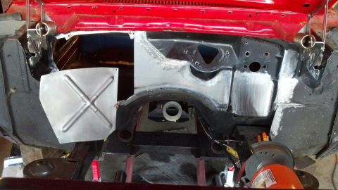 1964 Ford Fairlane - Close-up view of a car's engine bay and firewall undergoing repair, showing metalwork and structural components.