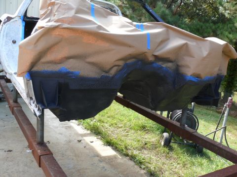 car body on stand, masked off for painting